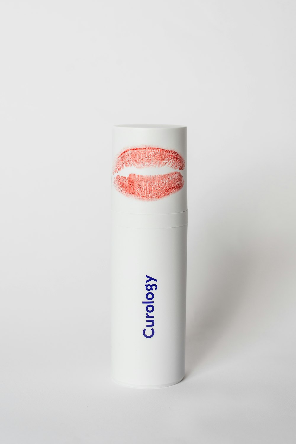 a tube of lipstick on a white background