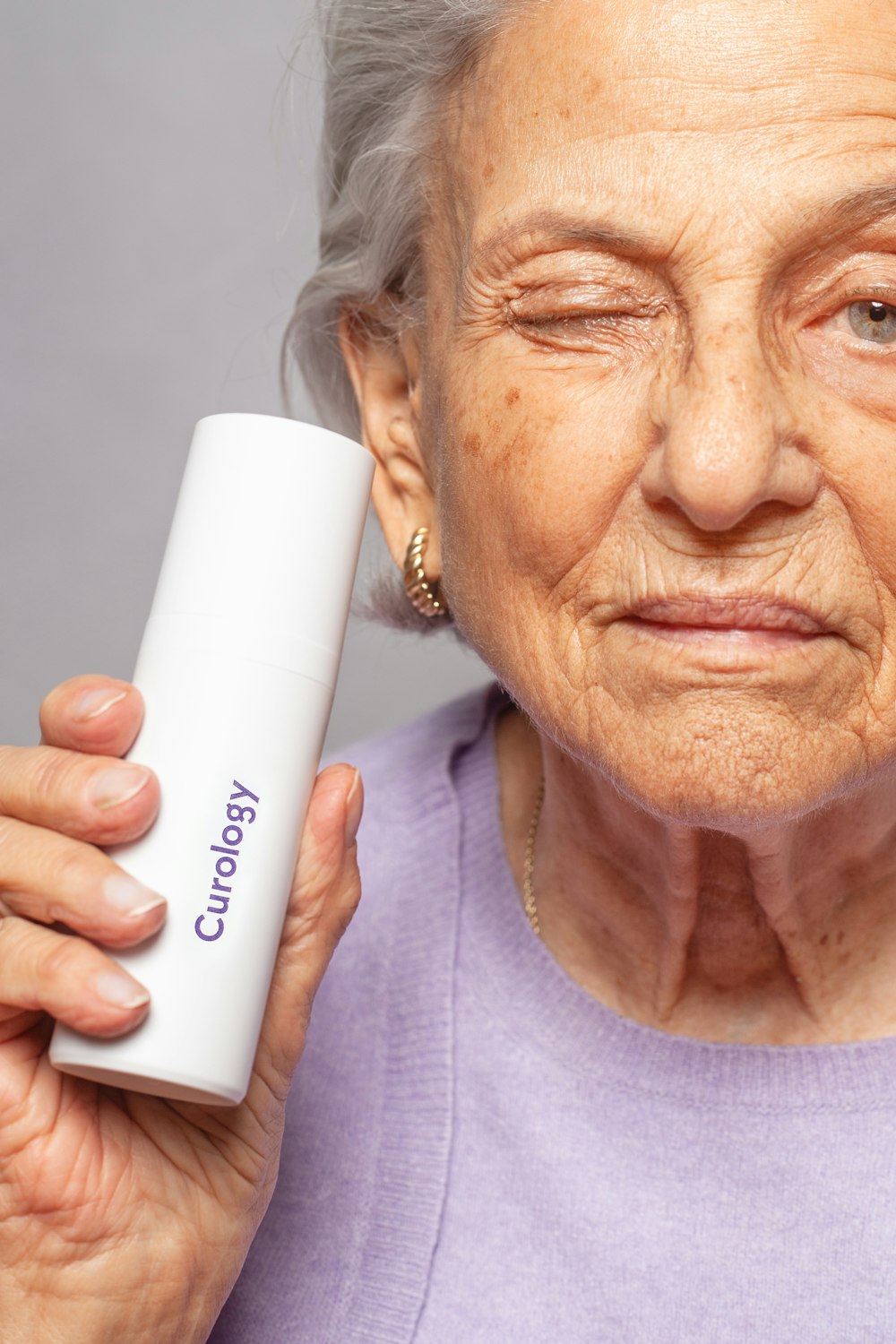 woman holding Curology bottle