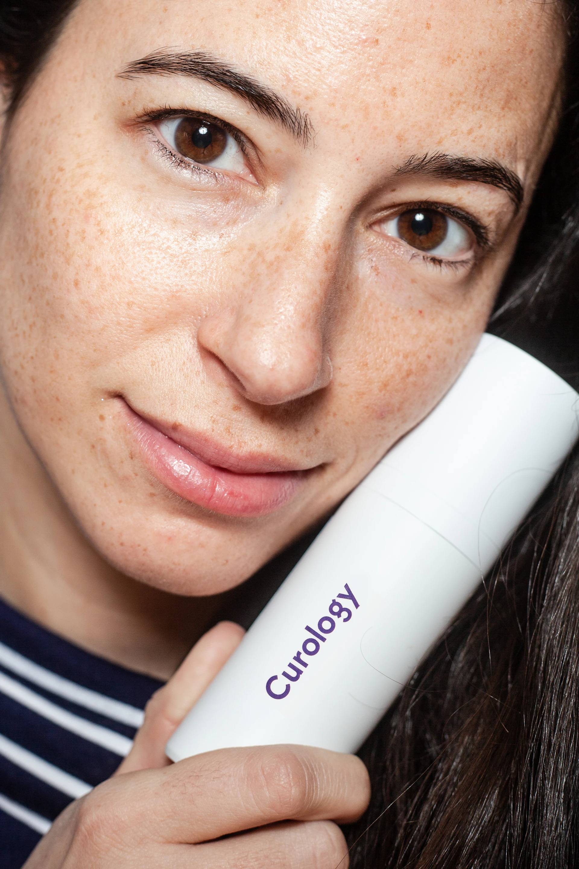 Dermatologist examining a patient's skin with a dermatoscope