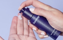 person holding Curology spray bottle