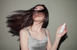 woman holding spray bottle