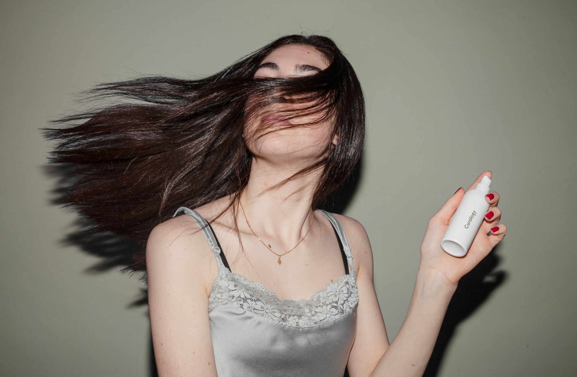 Woman holding spray hair product