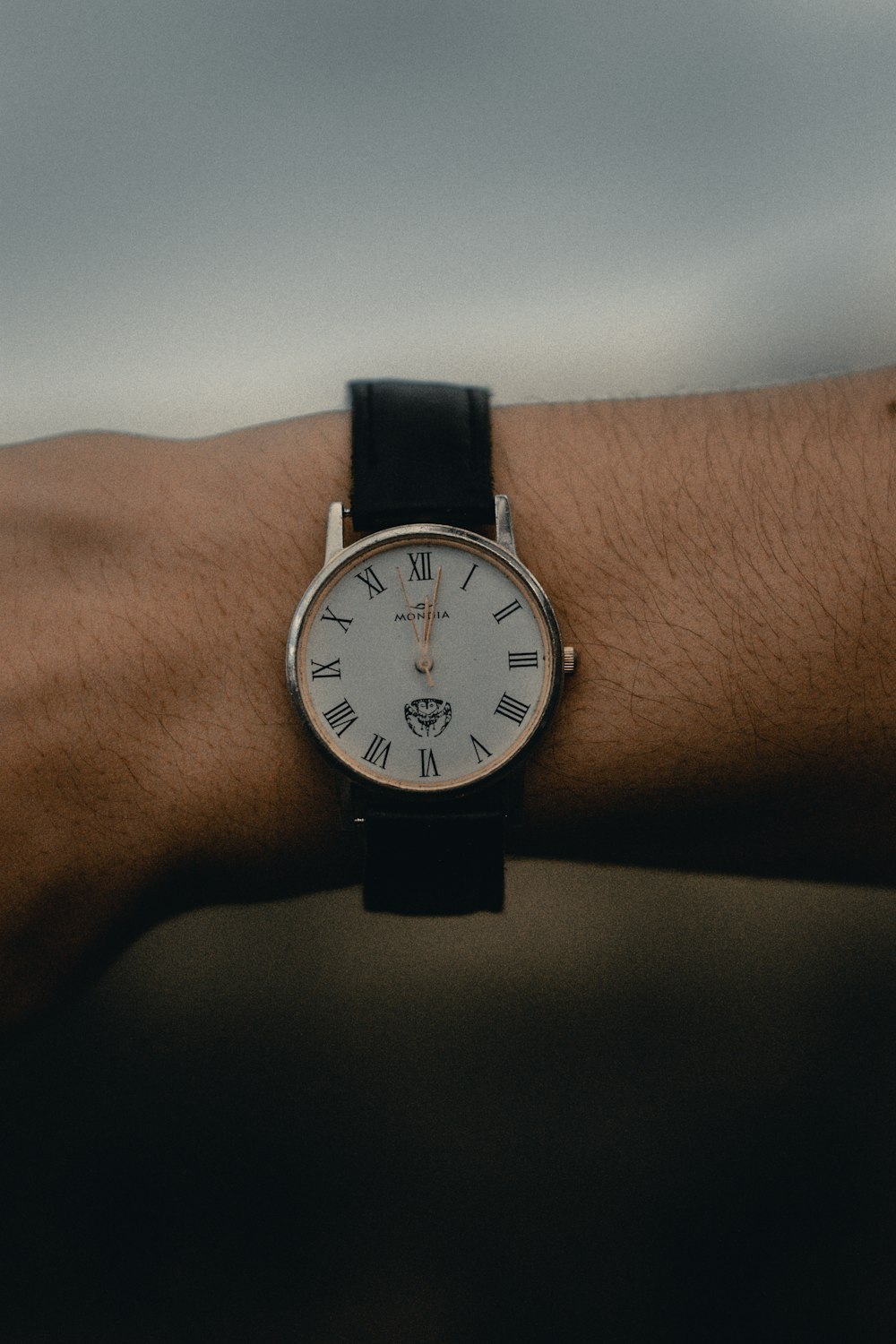 round white and silver-colored analog watch