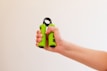 Young person holding a hand gripper with a focused expression during workout.