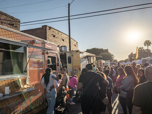 A vibrant snapshot of a bustling Vancouver food truck festival with colorful trucks and happy visitors.