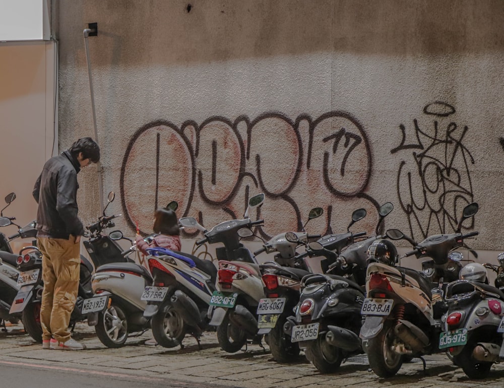 man looking at motorcycle during daytime