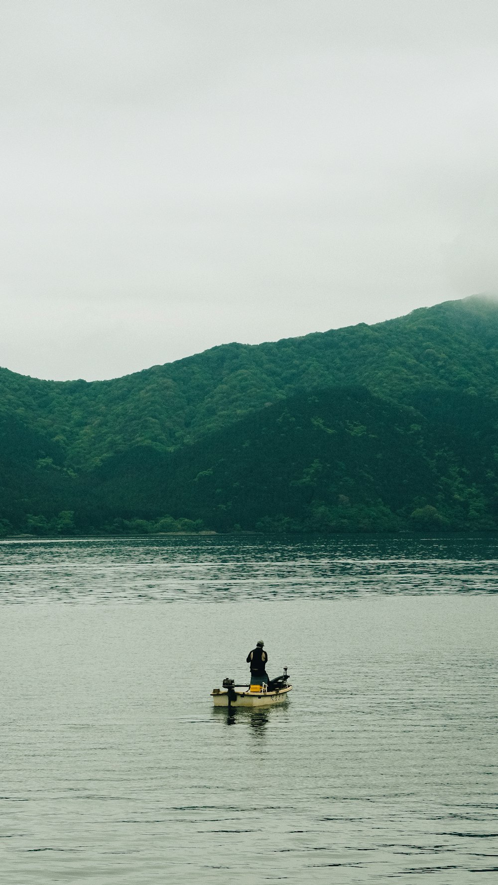 man riding boat on lake