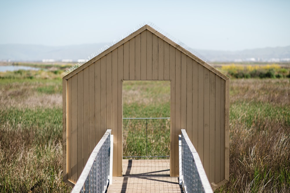 brown wooden wall near green grass