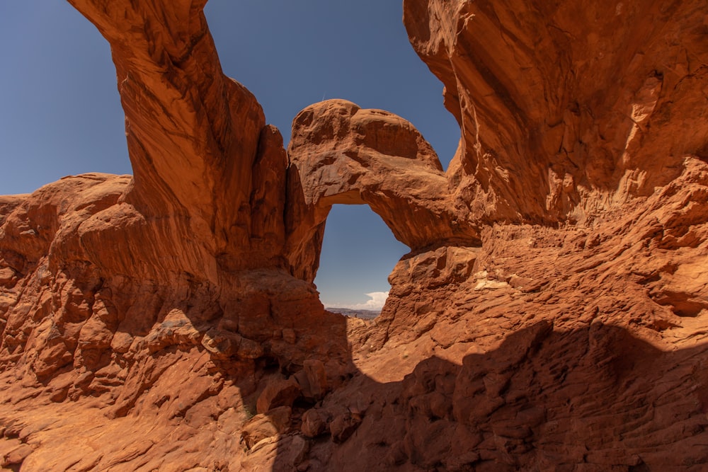 a rock formation in the desert with a sky background