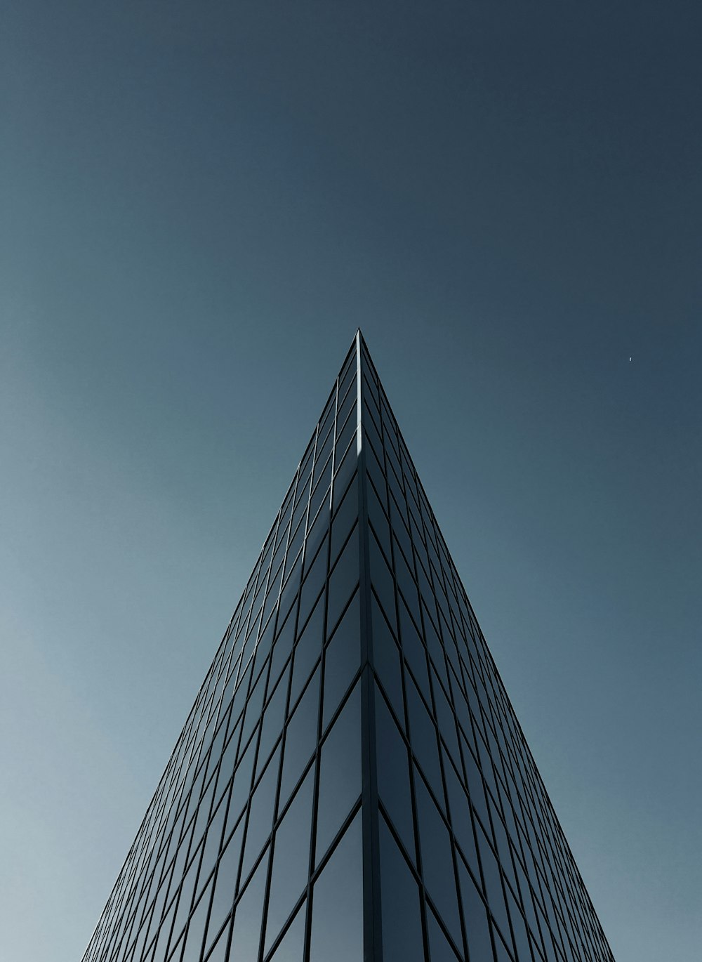 low angle photography of glass building under clear sky