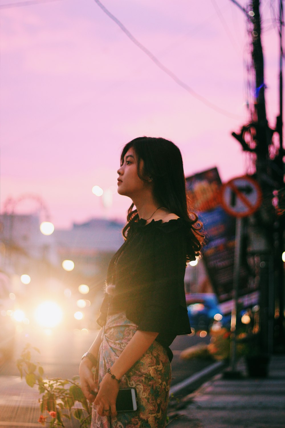 woman standing near post