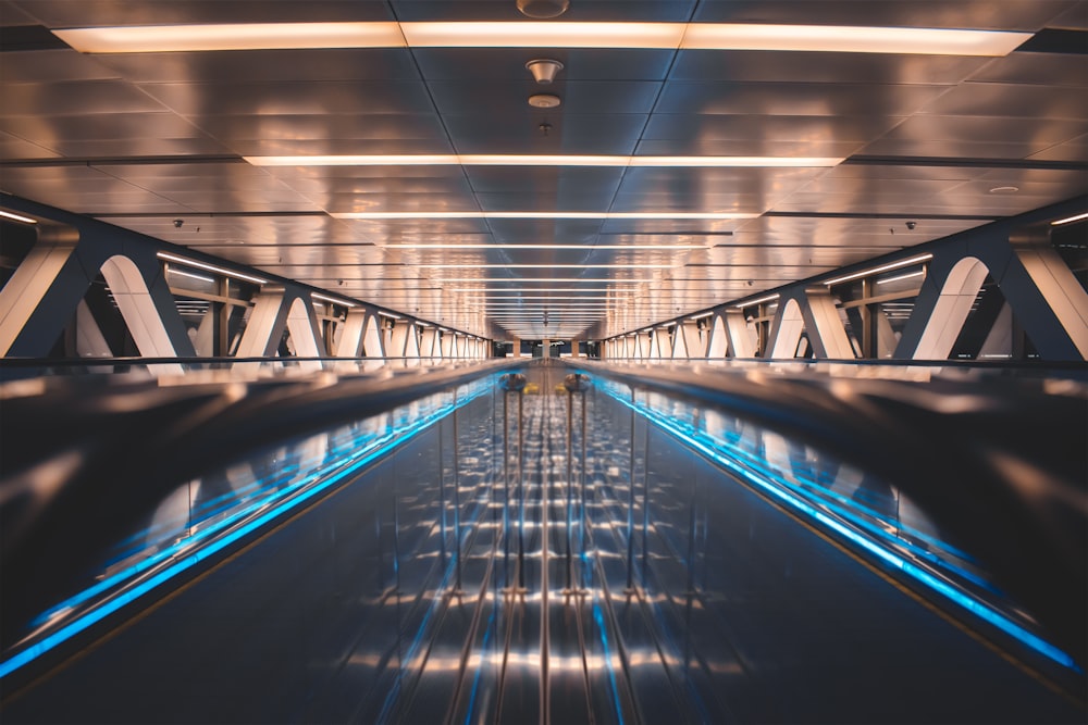 a very long and empty walkway with blue lights