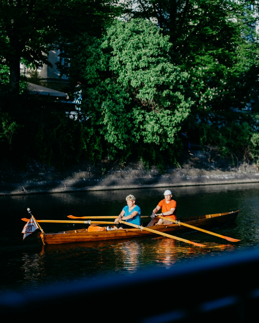 man and woman rowing in boat