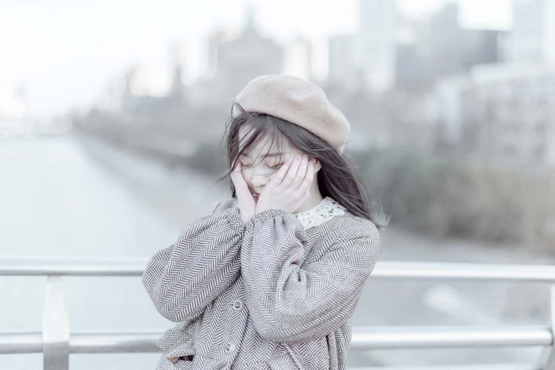 woman placing her both hands on her cheeks