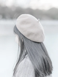 Modern blowout with volume and shine against a minimalist beige backdrop