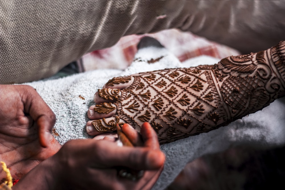 person with foot mendhi tattoo