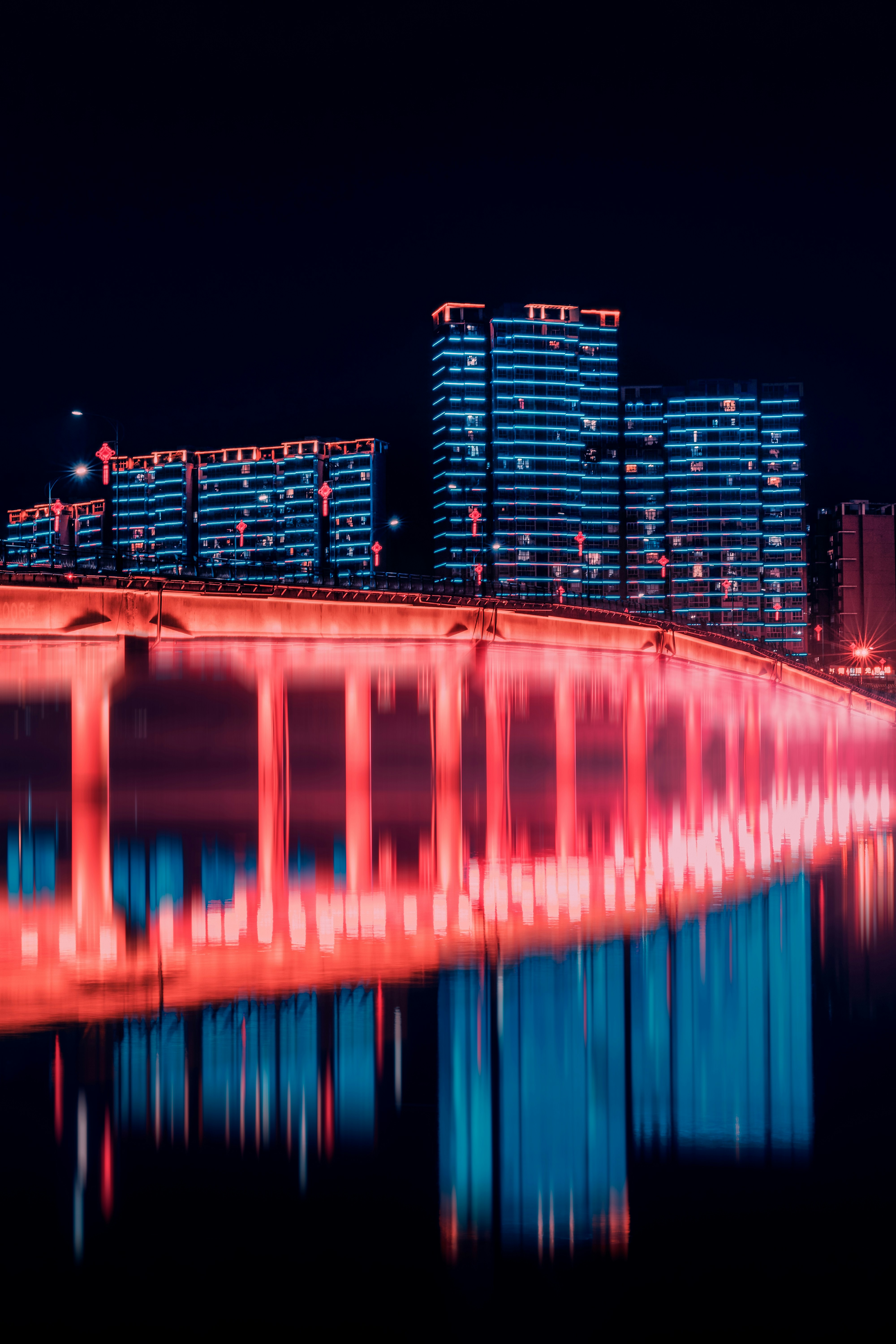 a bridge that is lit up in red and blue