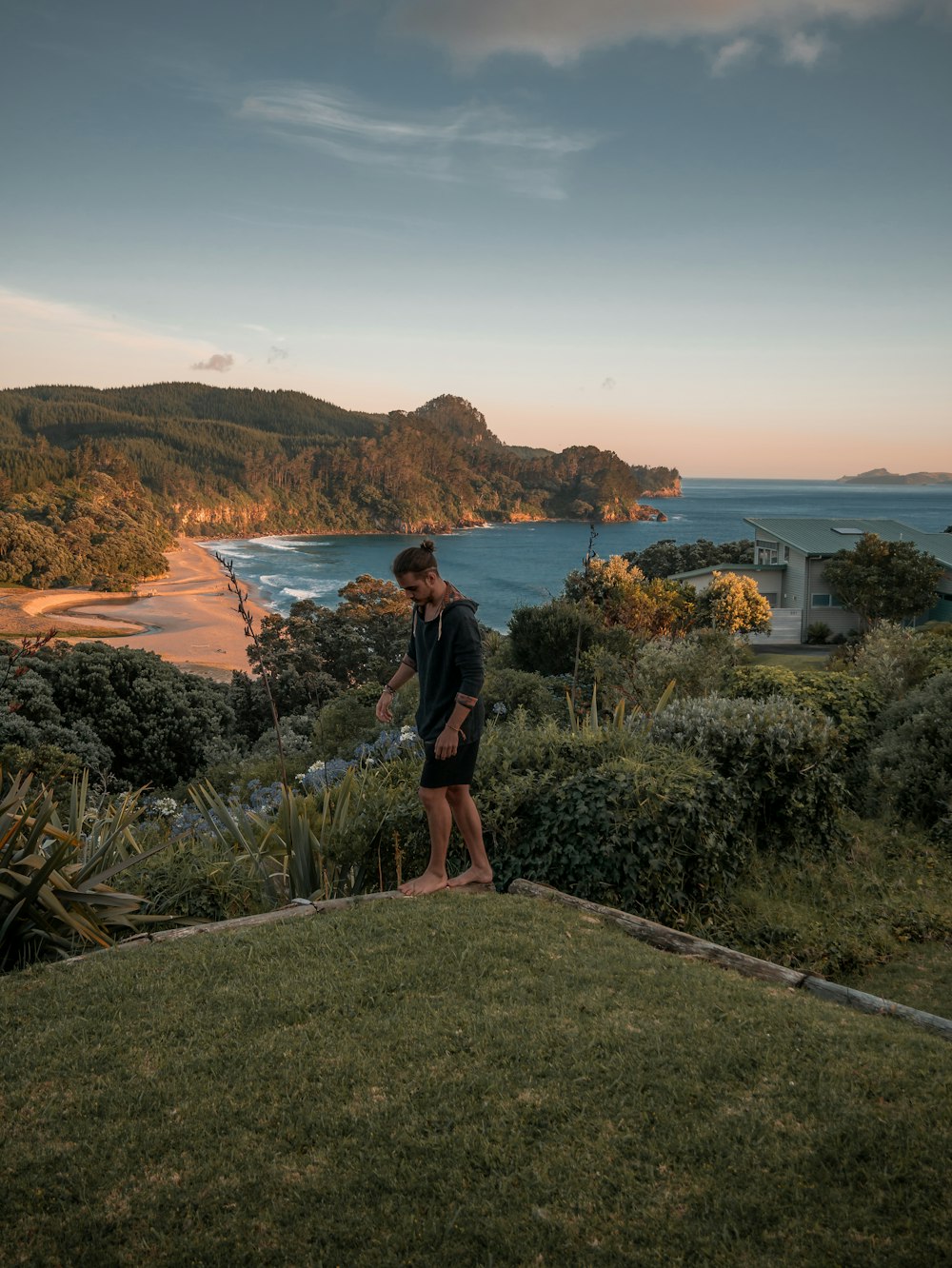 man in black hoodie standing on grass