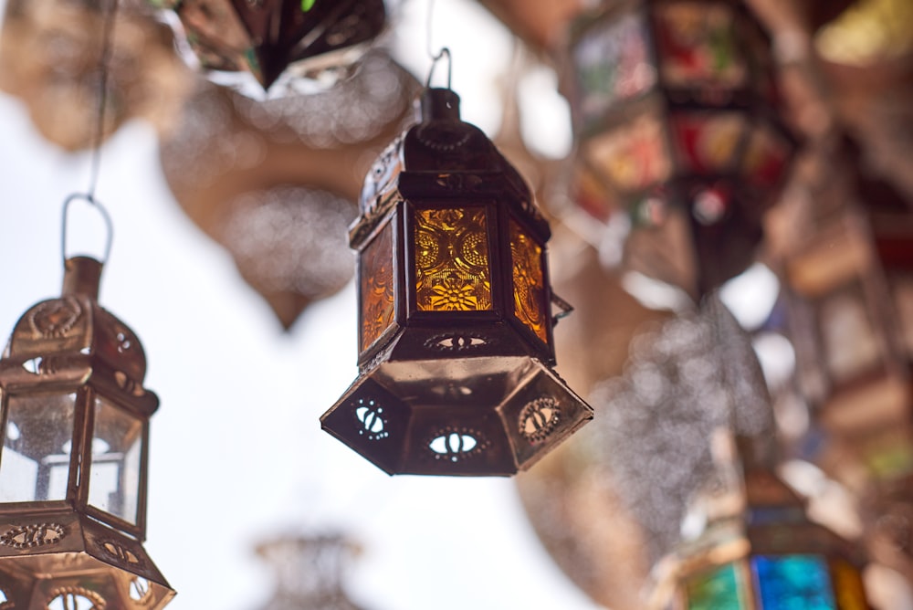 selective focus photography of hanging candle lantern