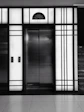 Modern home elevator interior showcasing sleek controls and customizable finishes.