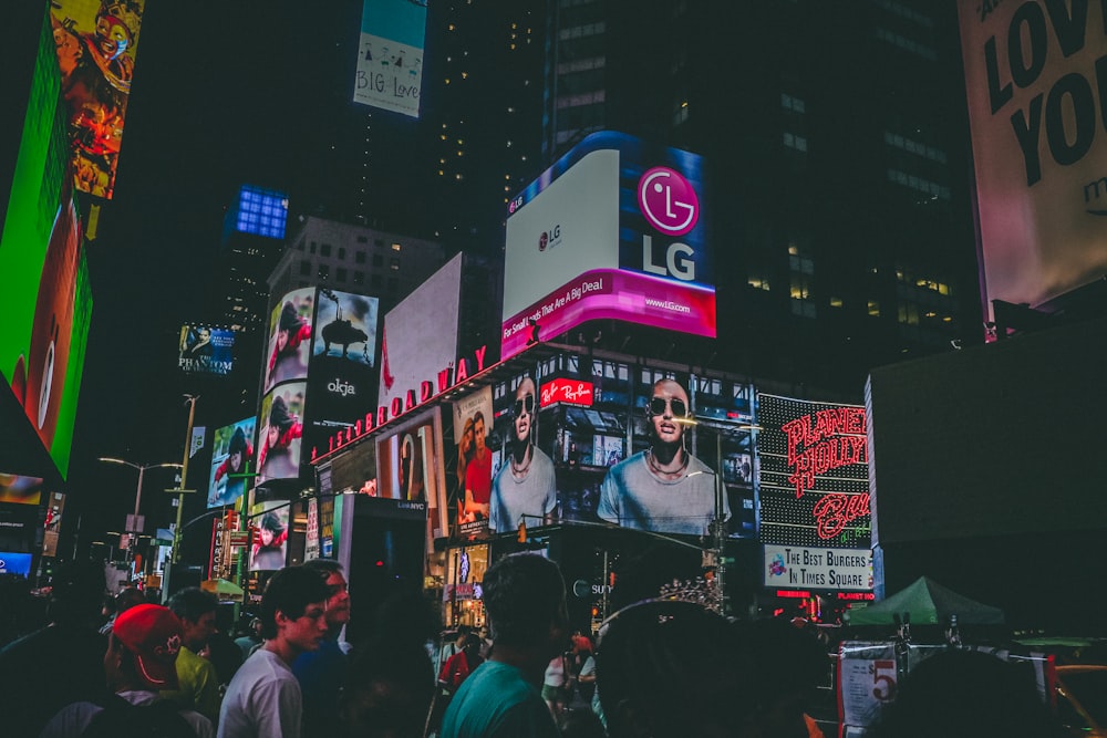 people in busy city street at night