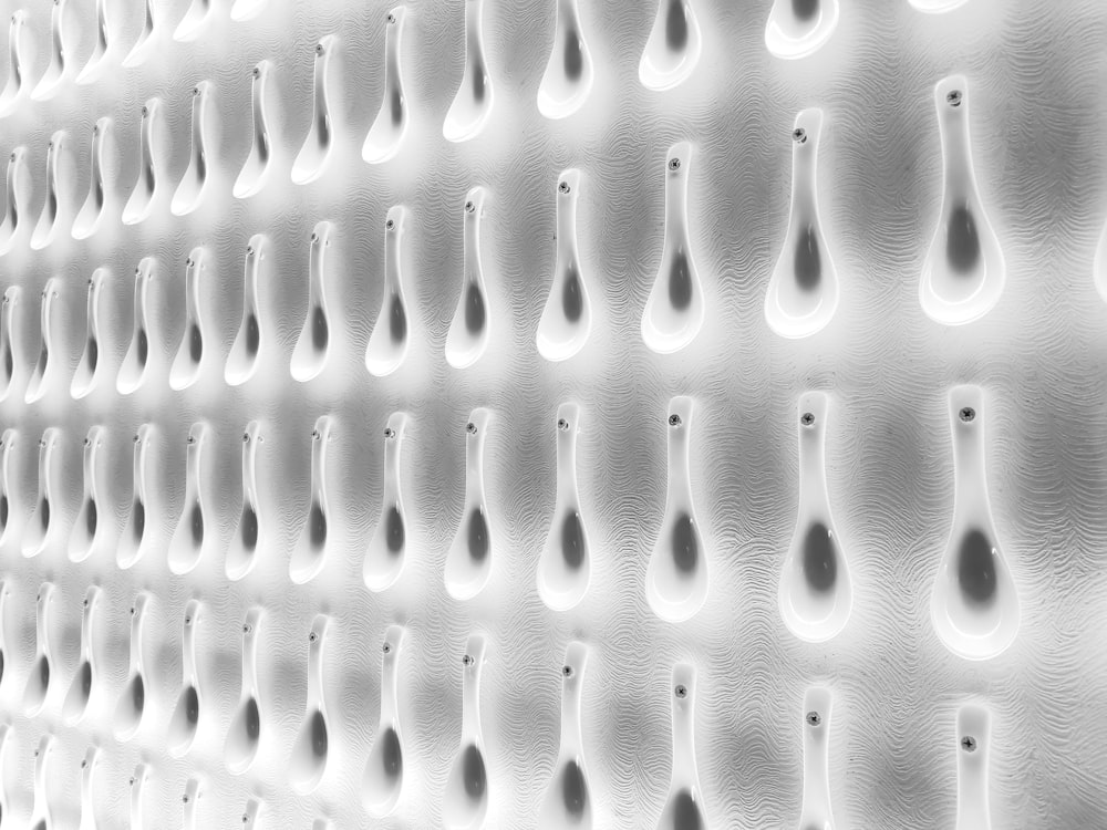 a white wall with a bunch of spoons on it