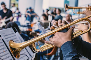 person playing trumpet in a brass band