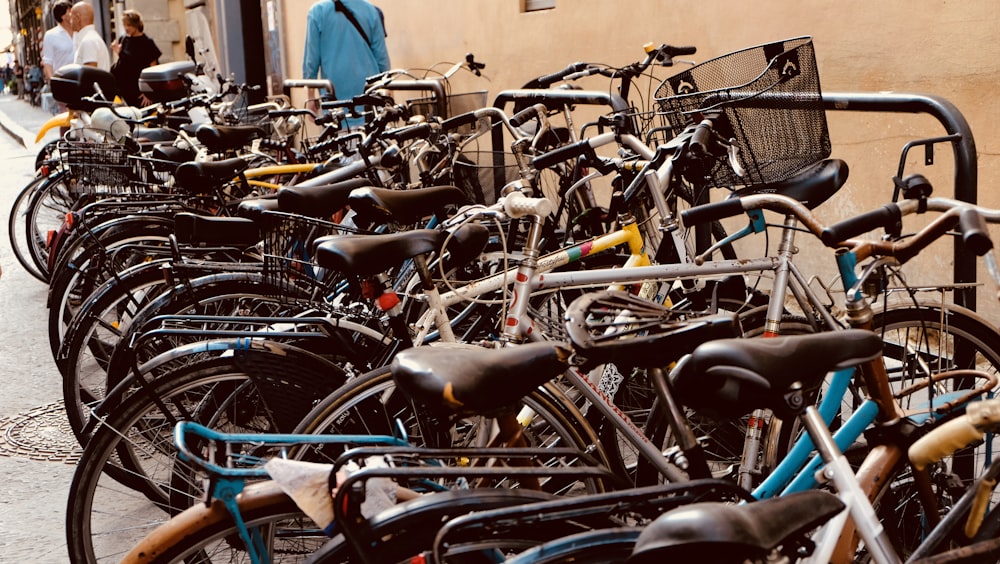 bicycles with different colors parked along sidewalk