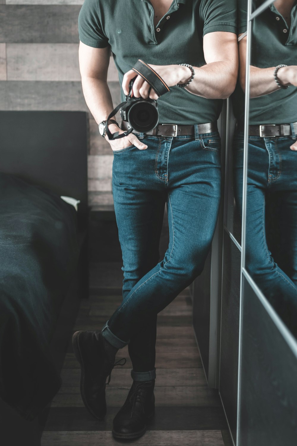 man holding DSLR camera inside room