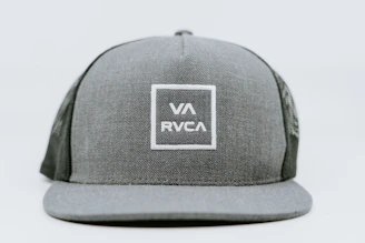 A sleek black cap embroidered with the vavrezine avc symbol in white thread.