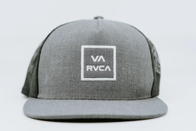 A sleek black cap embroidered with the vavrezine avc symbol in white thread.