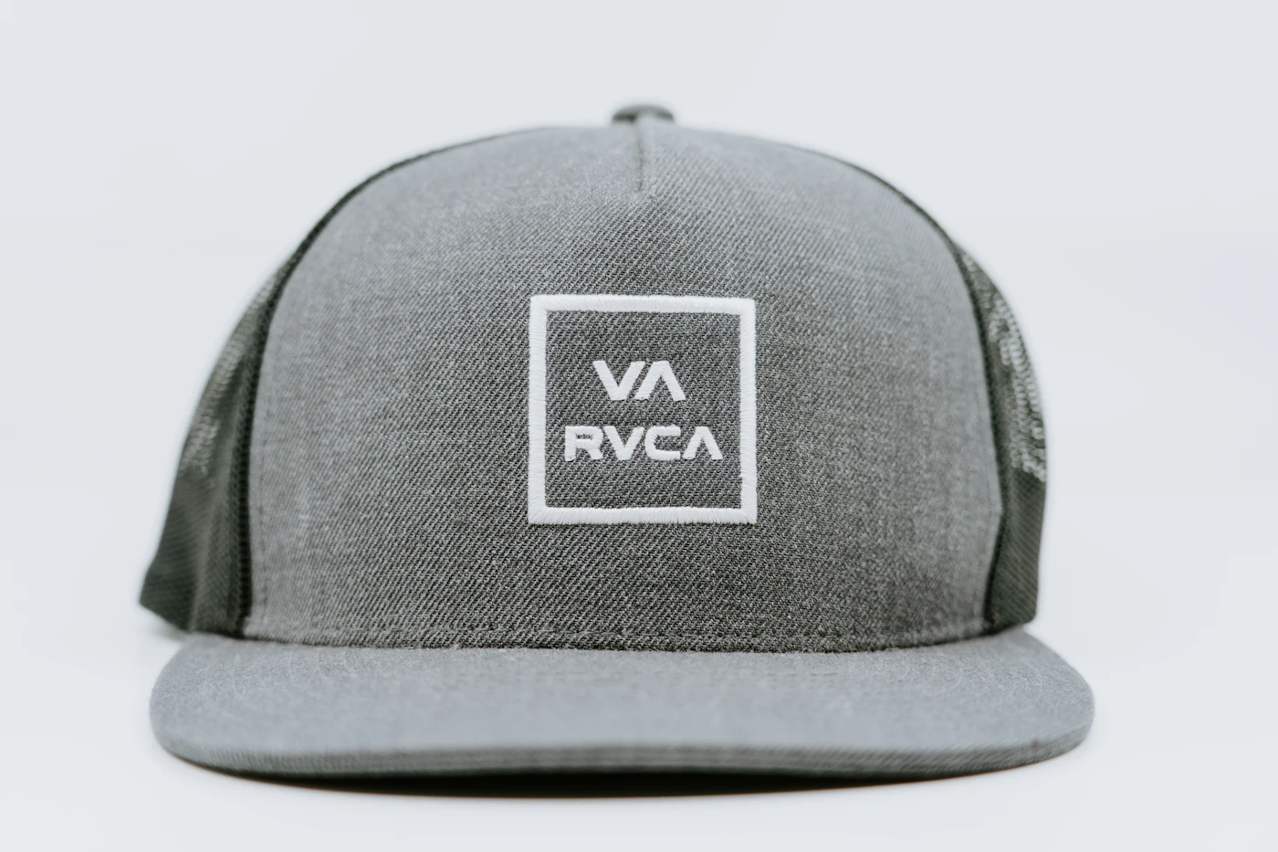 Runner wearing a trucker cap on a trail in cool weather