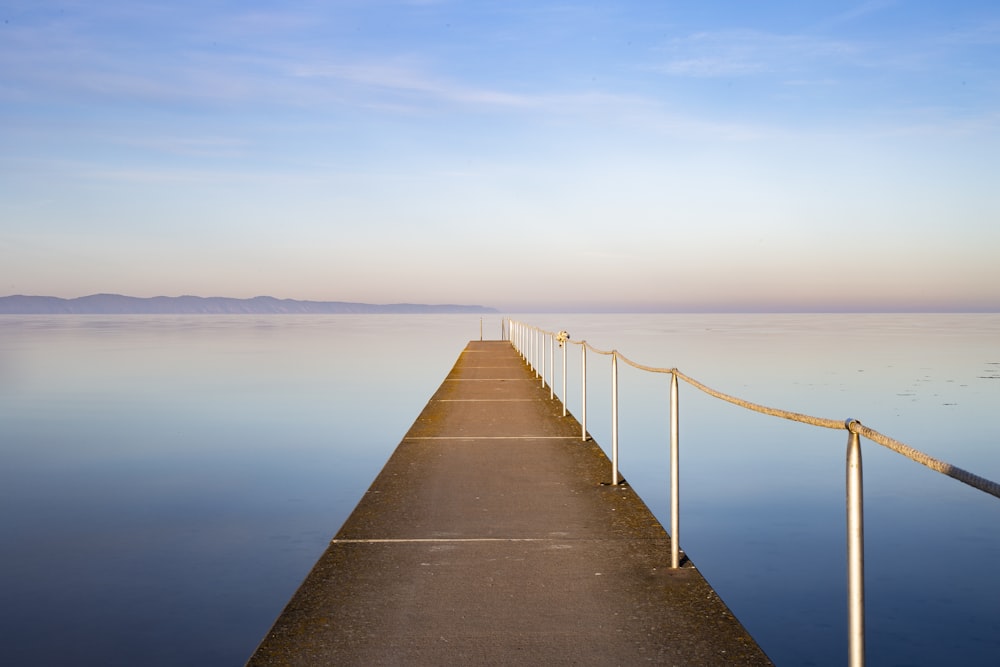 a long pier stretches out into the water