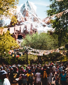 people gathered on foot of snow capped mountain