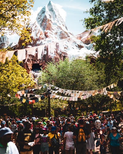 people gathered on foot of snow capped mountain