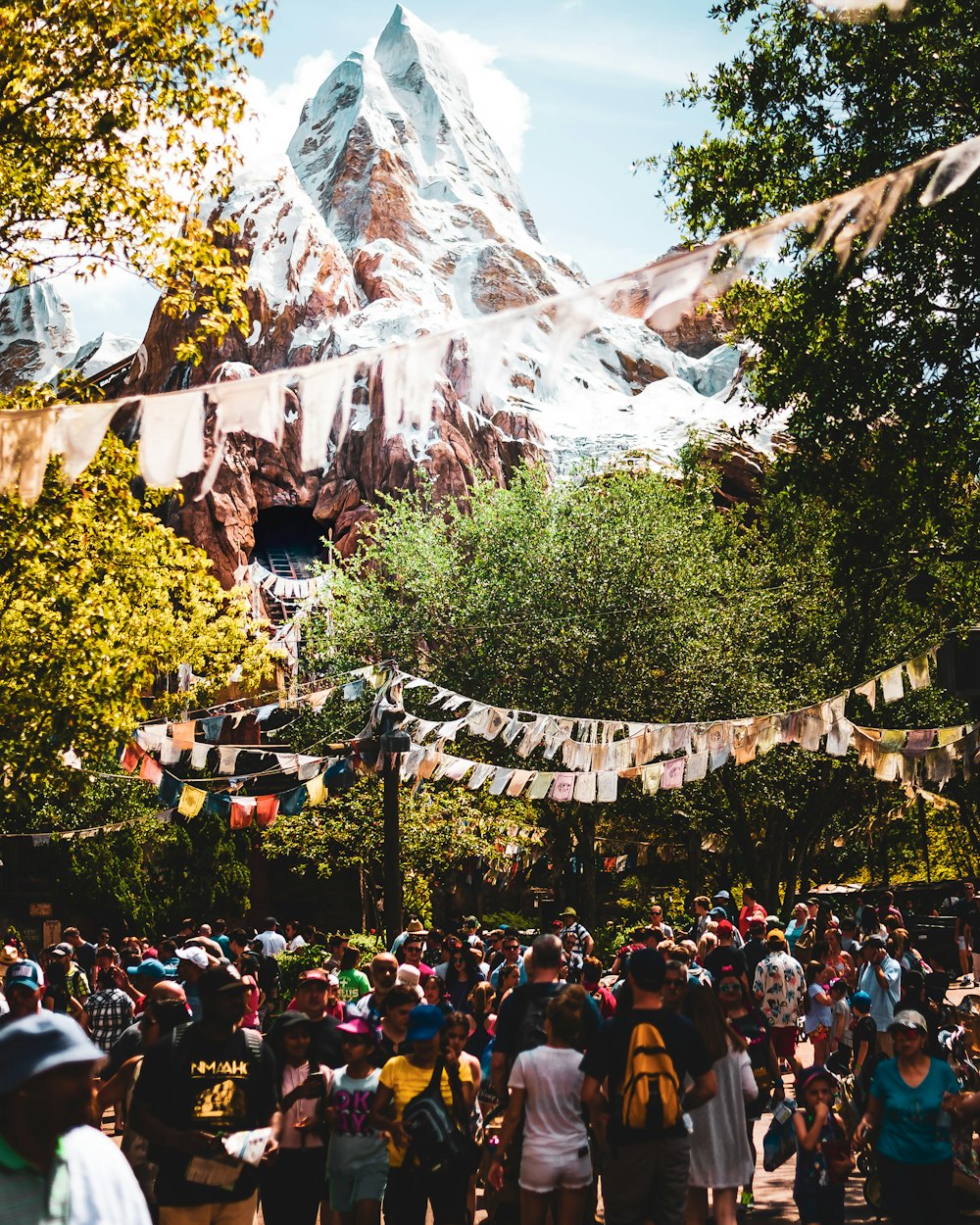 people gathered on foot of snow capped mountain