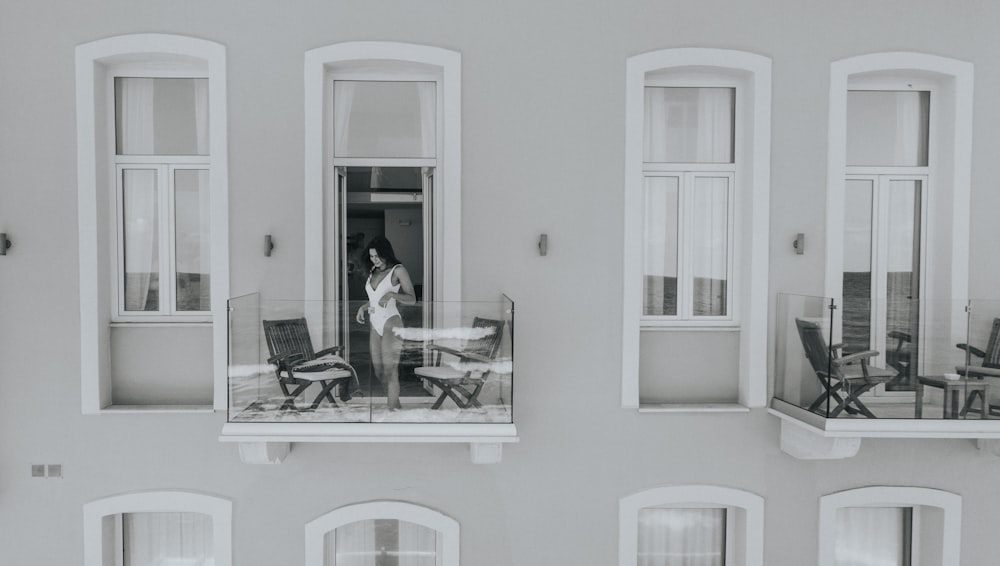 woman in white monokini in building balcony