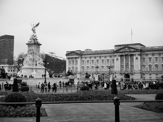 grayscale photo of people near building in Buckingham Palace United Kingdom