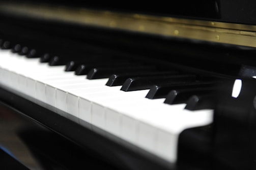 Close-up of hands testing a digital piano keyboard with large, clear keys.