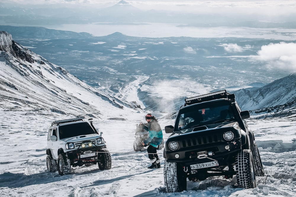 a couple of jeeps that are in the snow