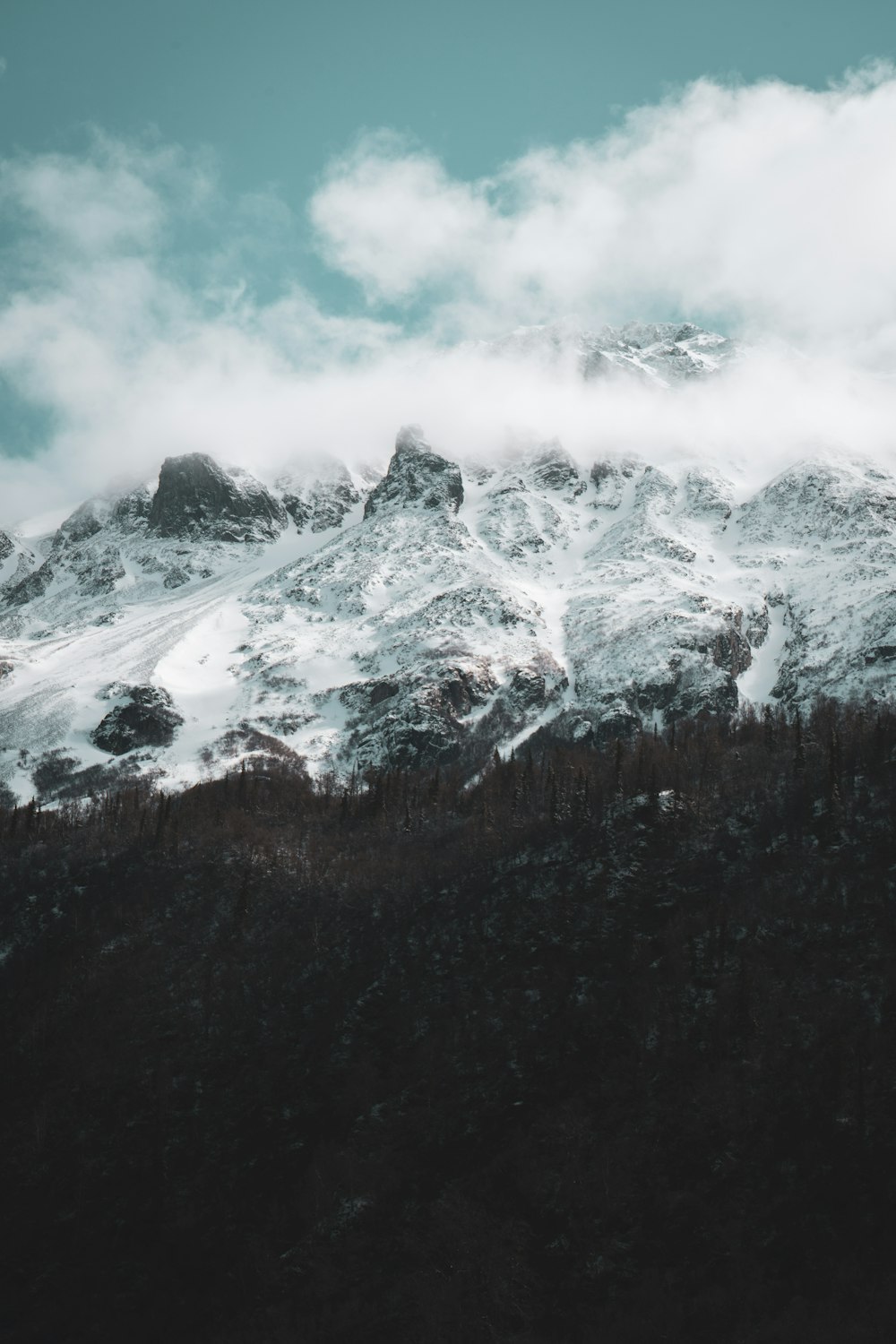 white rocky mountain with clouds