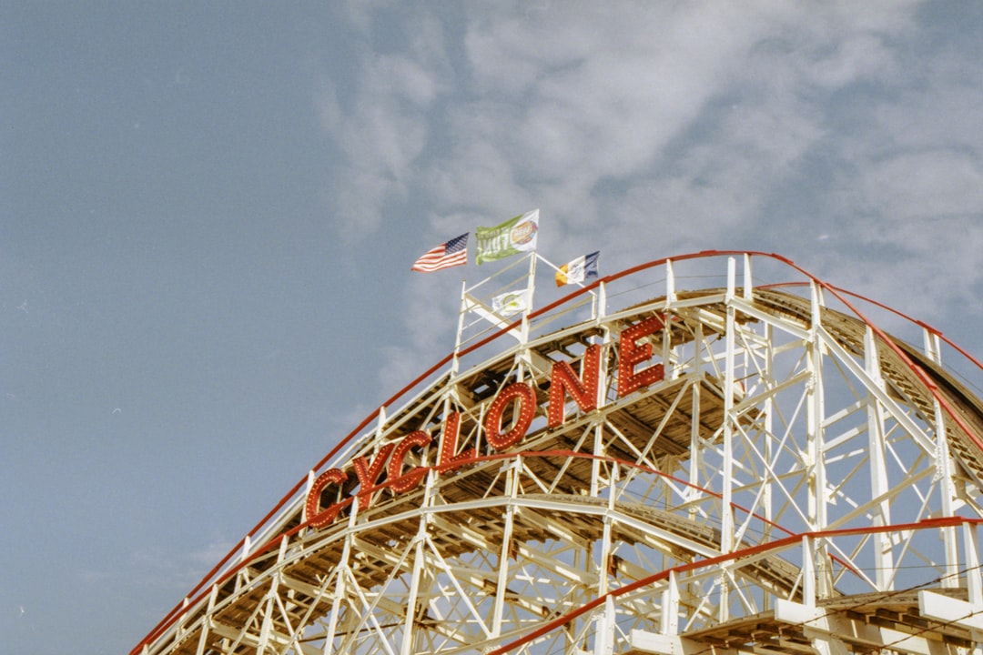 white and red roller coaster during daytime