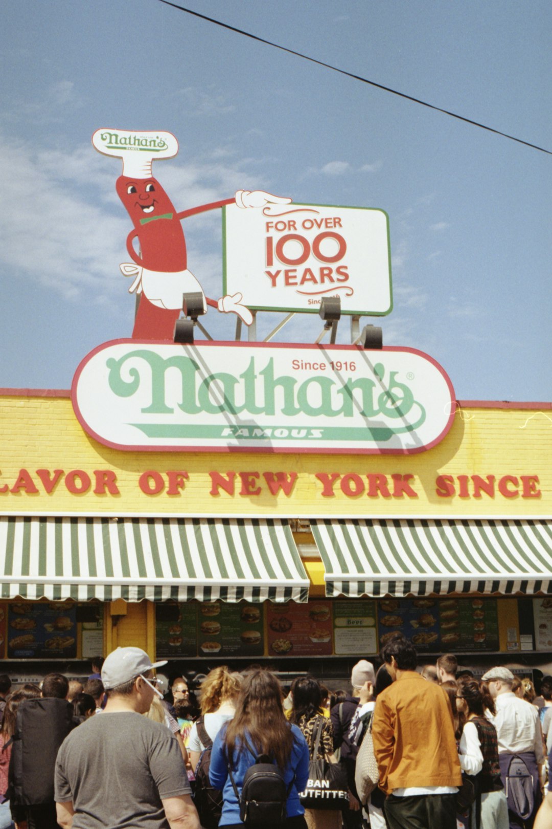 people gathering in front of Nathan's store