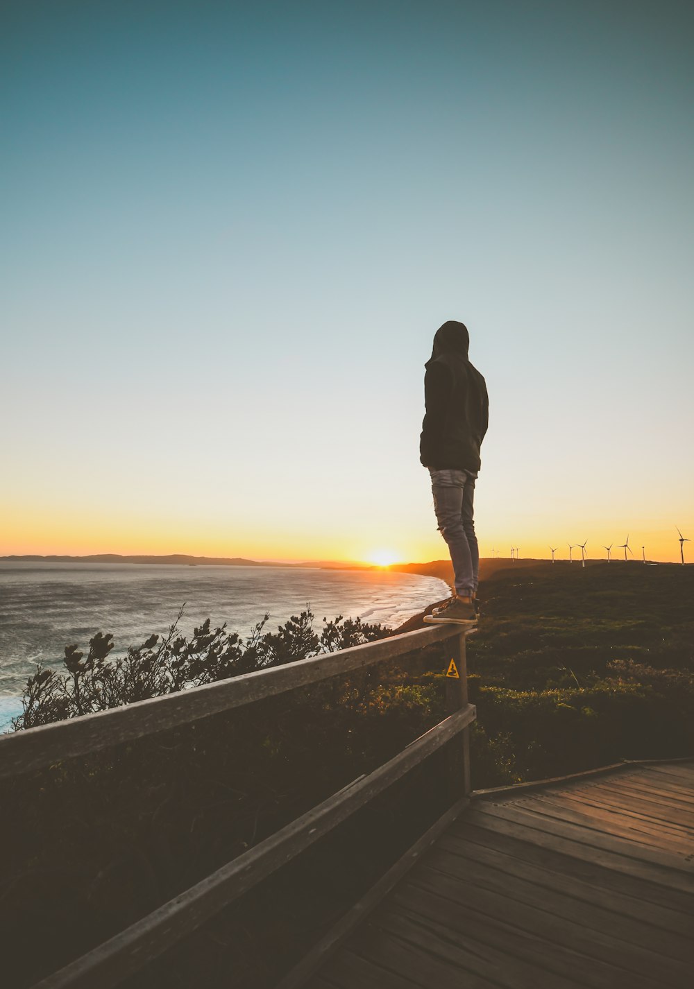 man standing on fence