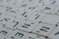 Close-up of colorful letter tiles arranged on a Boggle board mid-game.
