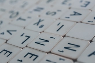 Close-up of colorful letter tiles arranged in a word search puzzle on a wooden table.