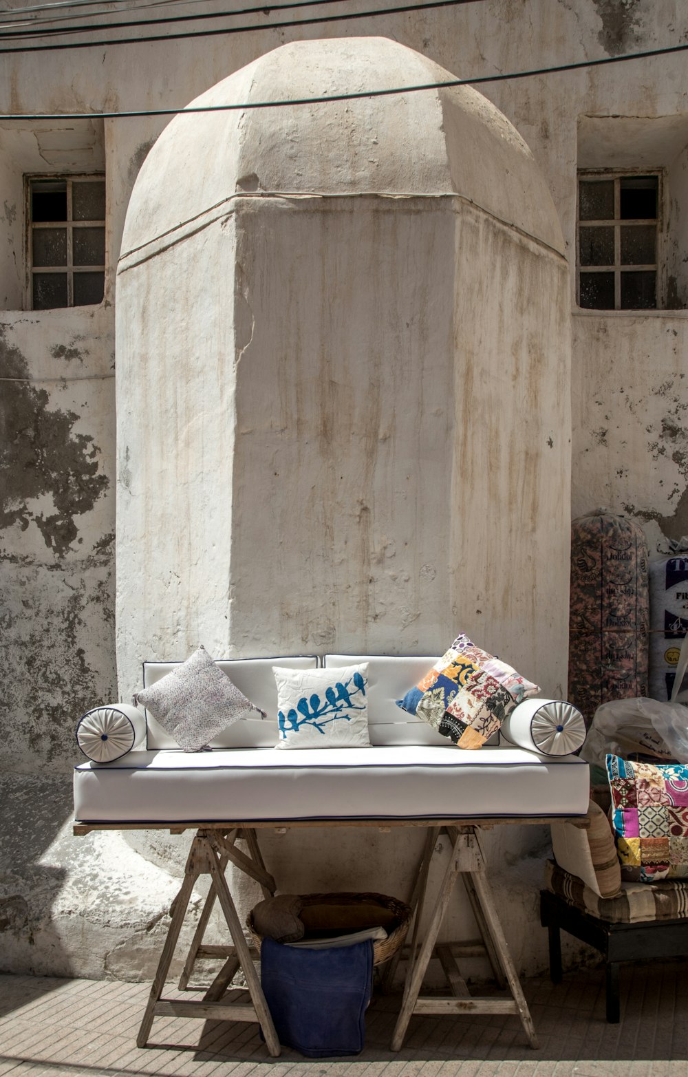 sofa with throw pillows near concrete structure