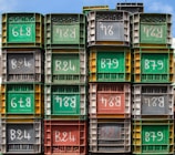 Industrial plastic crates stacked neatly in a warehouse setting.