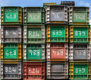 Various colors of plastic carrier tapes arranged in a neat stack