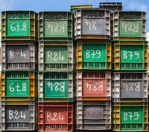 A stack of durable rental crates with the Eastbourne EquipRent logo